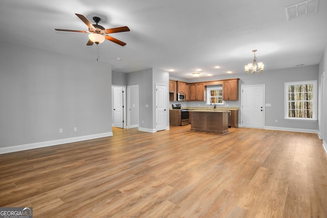 3177 Rodgers Creek Rd Unit 169, Ellijay, GA 30540 - unfurnished living room featuring a chandelier, a ceiling fan, and light wood-type flooring