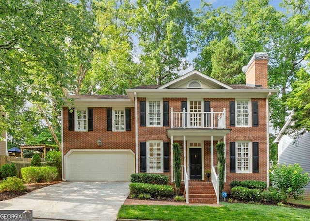 1117 Haven Glen Ln NE, Brookhaven, GA 30319 - colonial house with a garage, driveway, brick siding, and a chimney