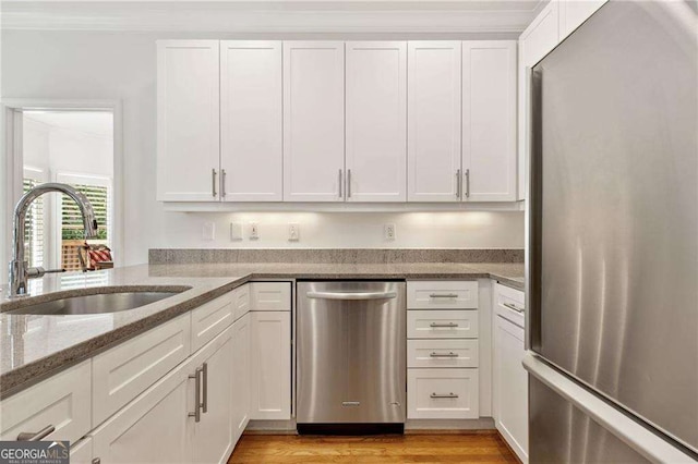 1117 Haven Glen Ln NE, Brookhaven, GA 30319 - kitchen featuring stainless steel appliances, white cabinets, and light stone counters