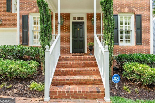 1117 Haven Glen Ln NE, Brookhaven, GA 30319 - doorway to property with brick siding and covered porch