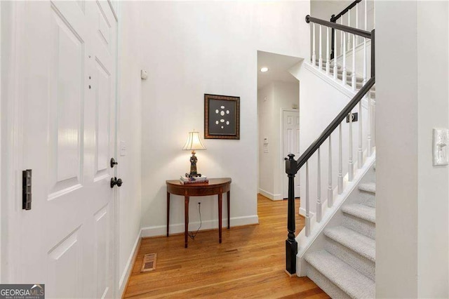 1117 Haven Glen Ln NE, Brookhaven, GA 30319 - foyer entrance with stairway, light wood-style floors, and a towering ceiling