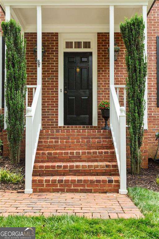 1117 Haven Glen Ln NE, Brookhaven, GA 30319 - property entrance featuring covered porch and brick siding