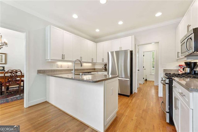 1117 Haven Glen Ln NE, Brookhaven, GA 30319 - kitchen with appliances with stainless steel finishes, dark stone countertops, white cabinets, recessed lighting, and ornamental molding
