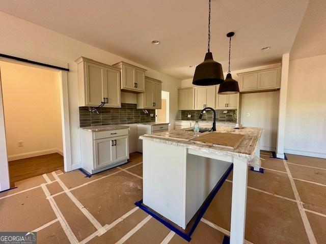 3609 Youngs Mill Rd, Hogansville, GA 30230 - kitchen featuring tasteful backsplash, hanging light fixtures, an island with sink, and recessed lighting
