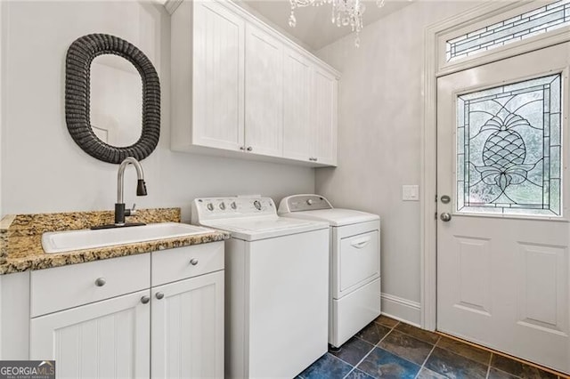 217 Fernwood Pl, Woodstock, GA 30188 - laundry room with cabinet space, washing machine and clothes dryer, healthy amount of natural light, and dark stone finish flooring