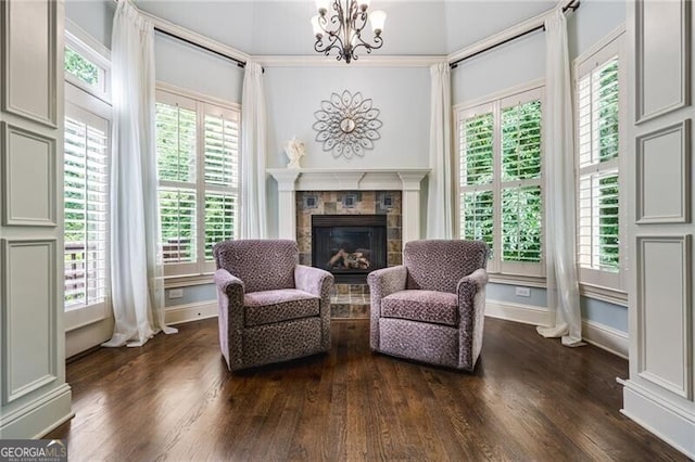 217 Fernwood Pl, Woodstock, GA 30188 - living area featuring a glass covered fireplace, dark wood-style floors, a chandelier, and healthy amount of natural light