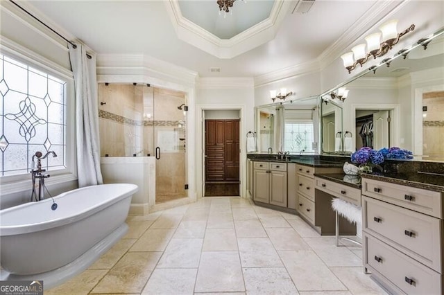 217 Fernwood Pl, Woodstock, GA 30188 - bathroom featuring a soaking tub, a shower stall, vanity, a tray ceiling, and ornamental molding