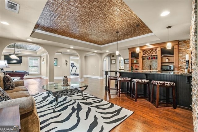 217 Fernwood Pl, Woodstock, GA 30188 - living room featuring a raised ceiling, arched walkways, billiards, crown molding, and recessed lighting