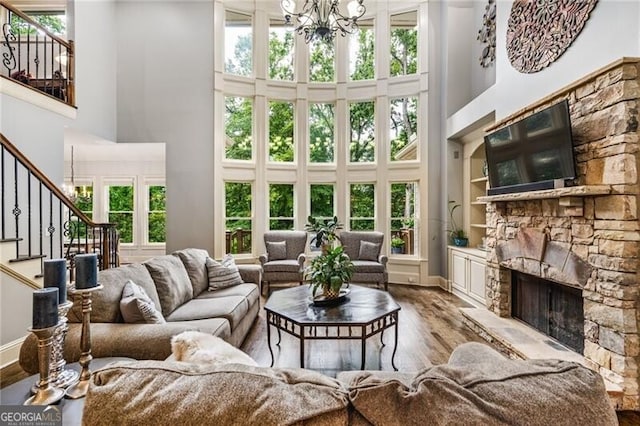 217 Fernwood Pl, Woodstock, GA 30188 - living area with a towering ceiling, stairs, wood finished floors, healthy amount of natural light, and a fireplace