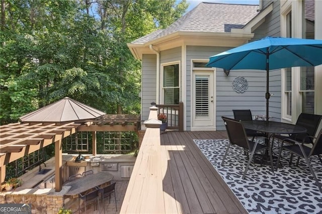 217 Fernwood Pl, Woodstock, GA 30188 - wooden deck with outdoor dining space and an outdoor kitchen