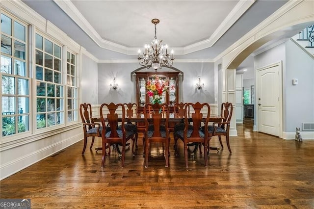 217 Fernwood Pl, Woodstock, GA 30188 - dining room with a chandelier, a raised ceiling, wood finished floors, healthy amount of natural light, and ornamental molding