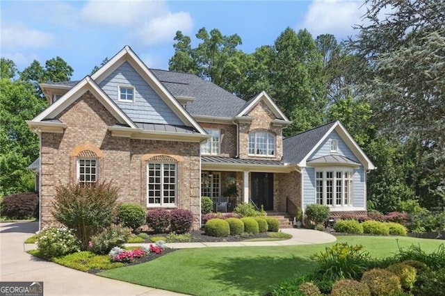 217 Fernwood Pl, Woodstock, GA 30188 - back of house with a lawn, a standing seam roof, a porch, and roof with shingles