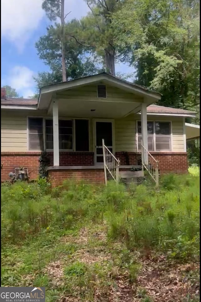 5103 NW Berry, Covington, GA 30014 - view of front of home featuring brick siding and a porch