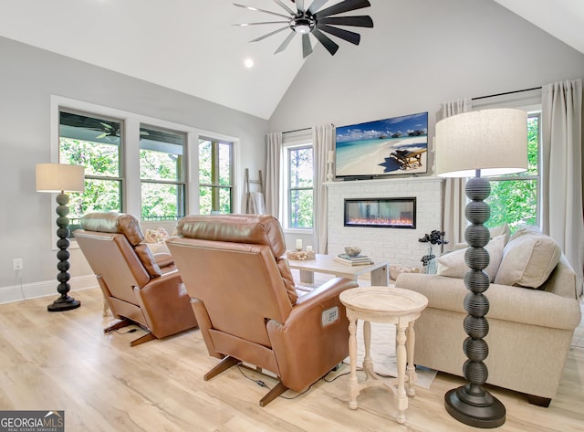 192 Greyfairs Ave, Senoia, GA 30276 - living area featuring high vaulted ceiling, a fireplace, a ceiling fan, light wood-style floors, and recessed lighting