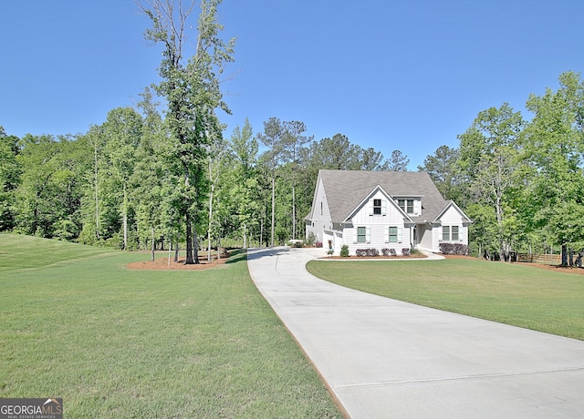 192 Greyfairs Ave, Senoia, GA 30276 - view of front of home with board and batten siding, concrete driveway, and a front yard