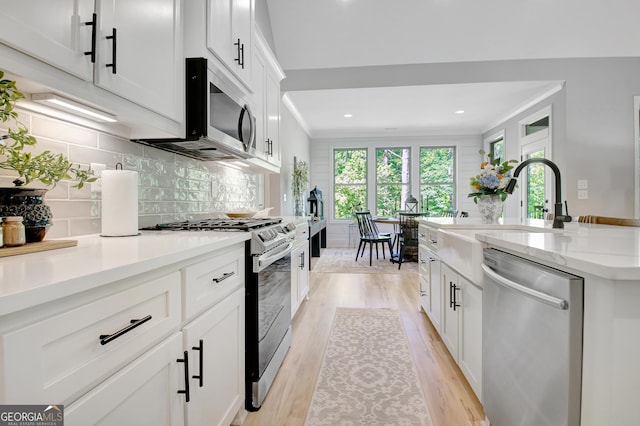 192 Greyfairs Ave, Senoia, GA 30276 - kitchen with stainless steel appliances, light wood-type flooring, plenty of natural light, decorative backsplash, and recessed lighting