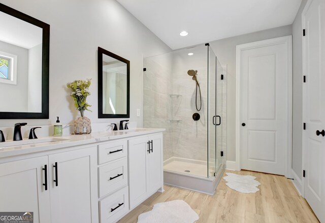 192 Greyfairs Ave, Senoia, GA 30276 - bathroom with a stall shower, double vanity, wood finished floors, and recessed lighting