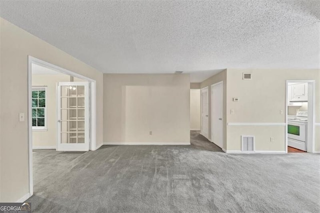 58 Monet Ct NW, Atlanta, GA 30327 - carpeted empty room with a textured ceiling and baseboards