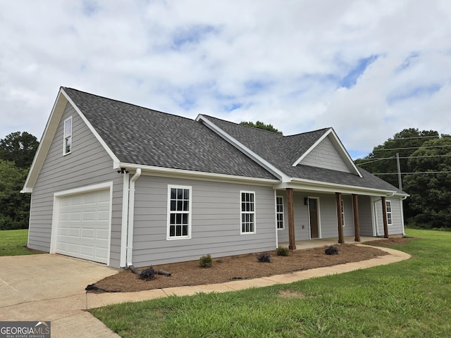 388 Kay Dr, Winder, GA 30680 - view of front of property with a porch, driveway, roof with shingles, a front lawn, and a garage