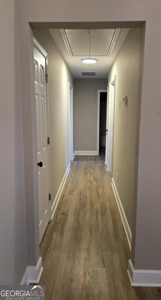 388 Kay Dr, Winder, GA 30680 - hallway featuring attic access and wood finished floors