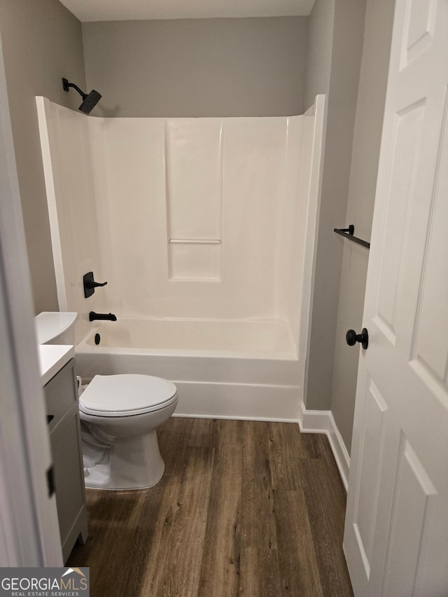 388 Kay Dr, Winder, GA 30680 - full bath with wood finished floors, vanity, and shower / bathtub combination