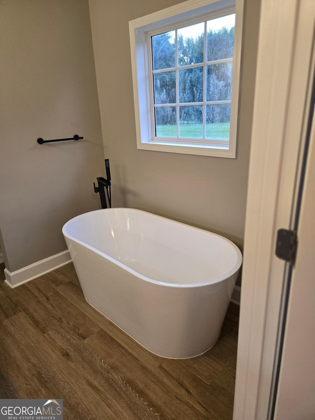 388 Kay Dr, Winder, GA 30680 - bathroom with wood finished floors and a freestanding bath