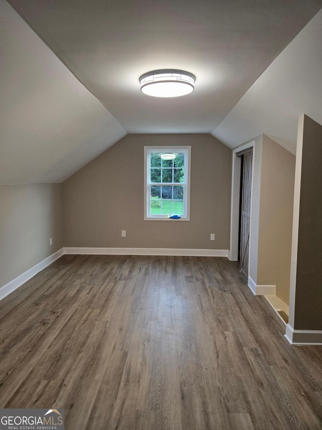 388 Kay Dr, Winder, GA 30680 - additional living space with dark wood-type flooring and vaulted ceiling