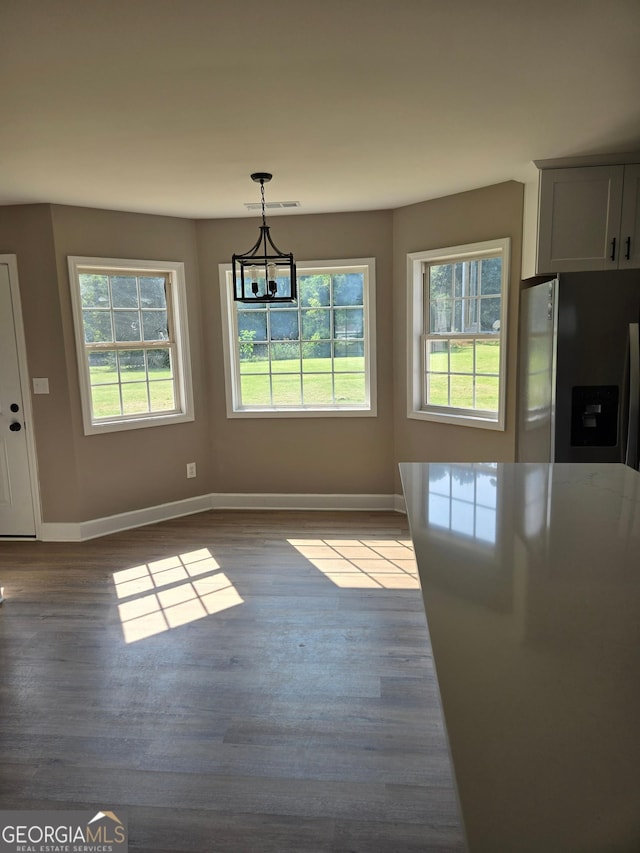 388 Kay Dr, Winder, GA 30680 - unfurnished dining area with a chandelier and wood finished floors