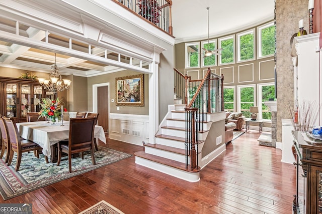 5717 Meadow View Dr, Jefferson, GA 30549 - dining area with a chandelier, stairs, hardwood / wood-style floors, plenty of natural light, and a wainscoted wall