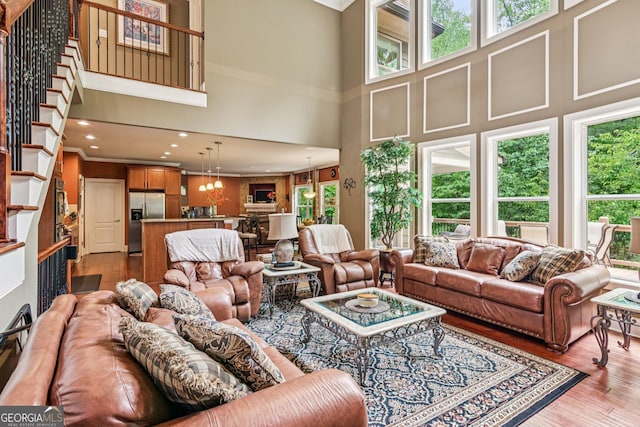 5717 Meadow View Dr, Jefferson, GA 30549 - living area with a towering ceiling, plenty of natural light, wood finished floors, recessed lighting, and stairs