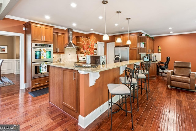 5717 Meadow View Dr, Jefferson, GA 30549 - kitchen featuring stainless steel appliances, wall chimney range hood, brown cabinets, a large island, and recessed lighting