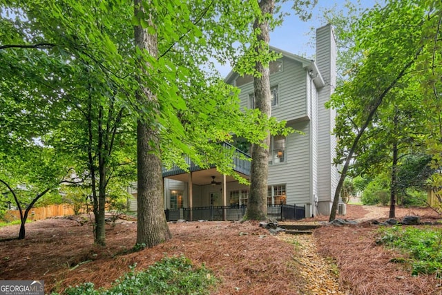 878 Treadstone Overlook, Suwanee, GA 30024 - rear view of property with ceiling fan and a chimney