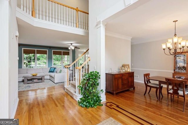 878 Treadstone Overlook, Suwanee, GA 30024 - dining space with stairs, a chandelier, light wood-style floors, crown molding, and ceiling fan