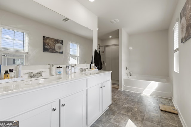545 Quail Pass, Dawsonville, GA 30534 - bathroom featuring a bath, double vanity, a stall shower, stone finish floors, and recessed lighting