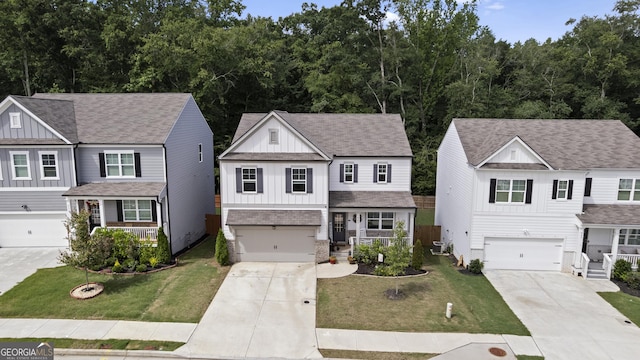 545 Quail Pass, Dawsonville, GA 30534 - view of front facade with board and batten siding, driveway, a garage, and a front lawn