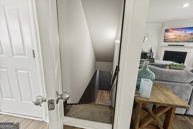 545 Quail Pass, Dawsonville, GA 30534 - stairway featuring wood finished floors, a glass covered fireplace, and crown molding