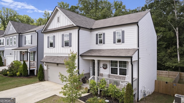545 Quail Pass, Dawsonville, GA 30534 - view of front facade with board and batten siding, a porch, concrete driveway, and a garage