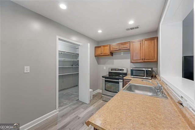 1455 Holleybrooke Dr, Alpharetta, GA 30004 - kitchen with appliances with stainless steel finishes, light wood-type flooring, light countertops, recessed lighting, and brown cabinets