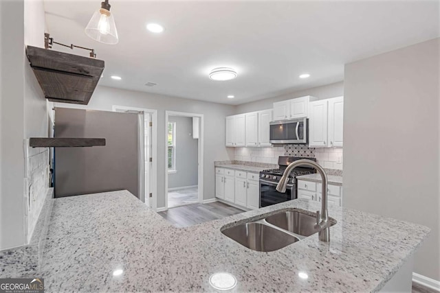 1455 Holleybrooke Dr, Alpharetta, GA 30004 - kitchen featuring stainless steel appliances, white cabinets, light stone countertops, tasteful backsplash, and light wood finished floors