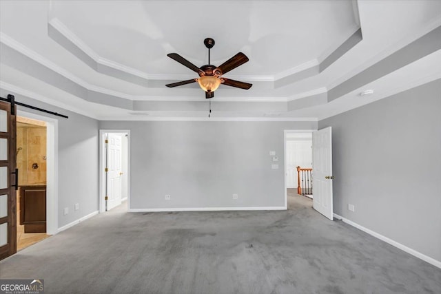 4157 Berkeley Lndg NW, Kennesaw, GA 30144 - empty room with a tray ceiling, a barn door, a ceiling fan, crown molding, and carpet