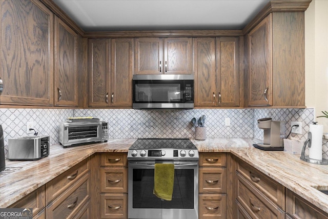 2204 Applebrook Dr, Rossville, GA 30741 - kitchen with appliances with stainless steel finishes, light stone counters, and backsplash
