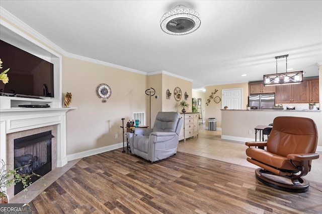 2204 Applebrook Dr, Rossville, GA 30741 - living room featuring wood finished floors, a tiled fireplace, and crown molding