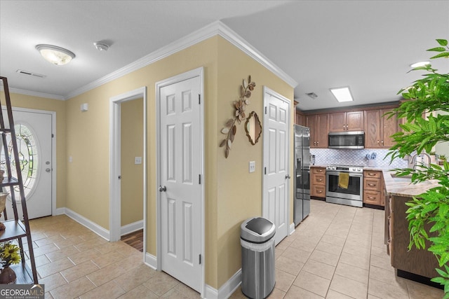 2204 Applebrook Dr, Rossville, GA 30741 - kitchen featuring stainless steel appliances, light tile patterned floors, light countertops, tasteful backsplash, and ornamental molding