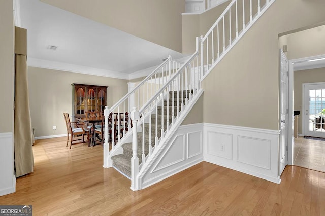 7325 Brookwood Way, Cumming, GA 30041 - stairs featuring wood finished floors, wainscoting, and crown molding