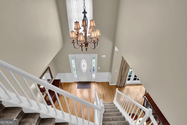 7325 Brookwood Way, Cumming, GA 30041 - foyer featuring stairs, a towering ceiling, a chandelier, and wood finished floors