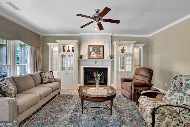 7325 Brookwood Way, Cumming, GA 30041 - living room with ornamental molding, a ceiling fan, a fireplace, and wood finished floors
