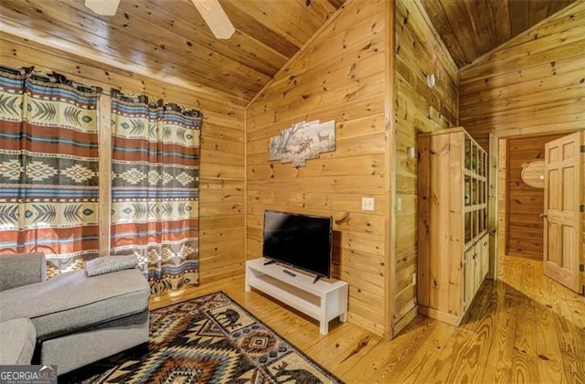 9947 Doublehead Gap Rd, Blue Ridge, GA 30513 - living room featuring lofted ceiling, wooden ceiling, wood walls, wood finished floors, and a ceiling fan