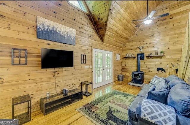 9947 Doublehead Gap Rd, Blue Ridge, GA 30513 - living room with french doors, a wood stove, wooden walls, wood finished floors, and wooden ceiling