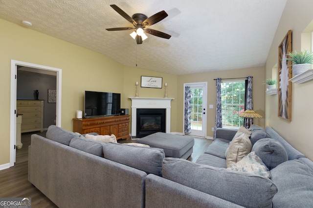67 Granite Ct, Dallas, GA 30132 - living area with dark wood-type flooring, a glass covered fireplace, a ceiling fan, and a textured ceiling