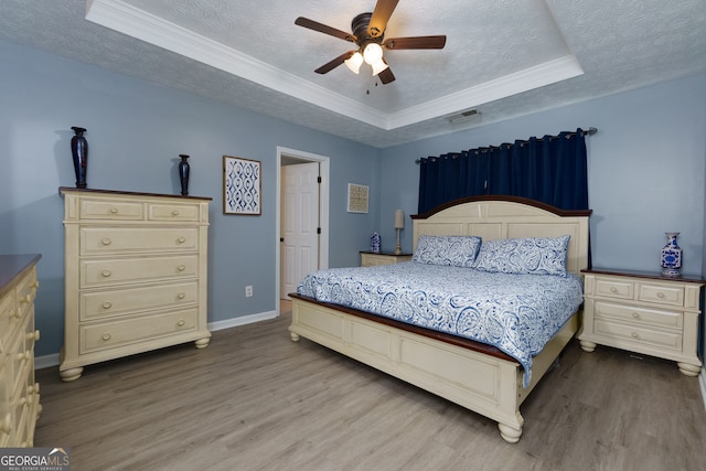 67 Granite Ct, Dallas, GA 30132 - bedroom with a raised ceiling, wood finished floors, a textured ceiling, ornamental molding, and a ceiling fan